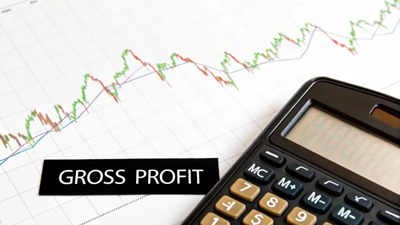 A magnifying glass over a calculator, symbolizing the focus on hidden trading costs.