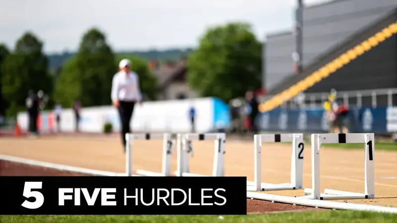 White hurdles numbered 1 and 2 on a running track